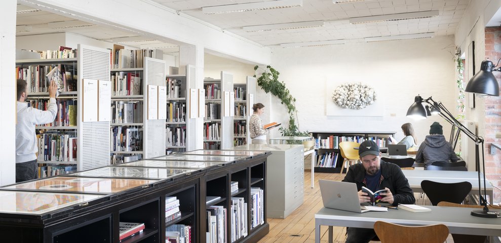 Reading area with people working in the Art and Design Sub-Library.