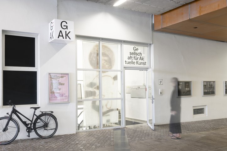 Entrance to GAK art gallery with glass windows and open doorway.