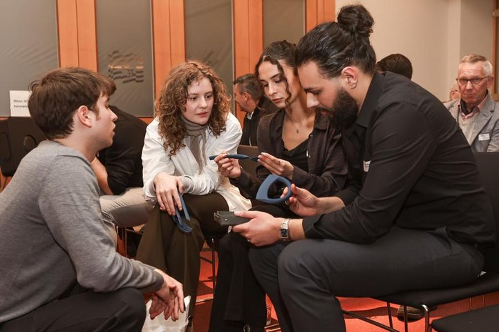 Emma Brzezina (2nd from left) presents her cutlery designs.