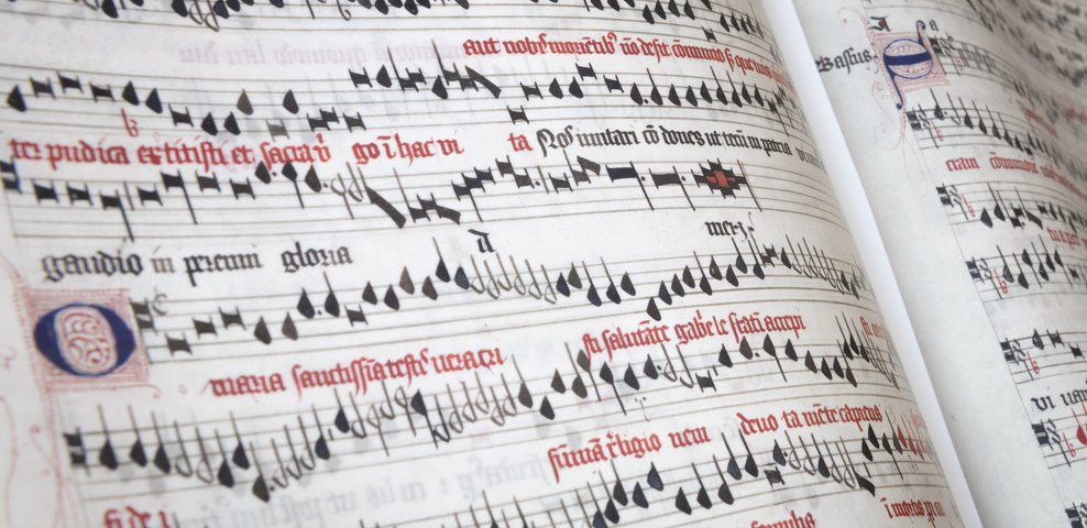 Historical music manuscript with red and black notation.