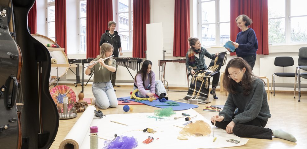 Music workshop on the floor with instruments and materials.